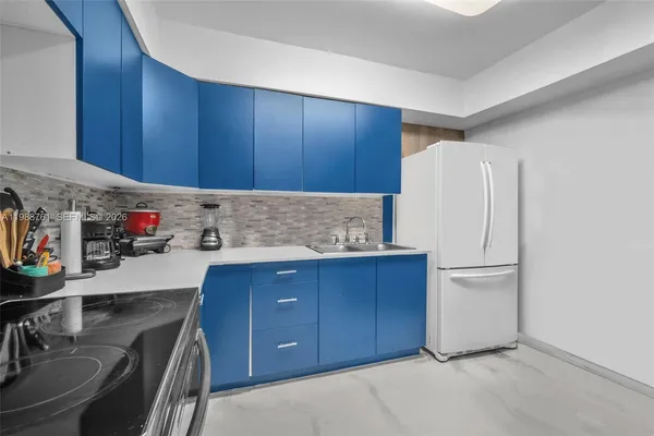 a kitchen with stainless steel appliances granite countertop a refrigerator and a stove