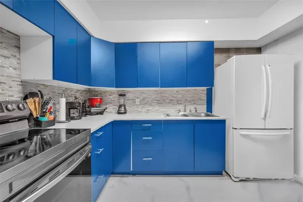 a kitchen with granite countertop wooden cabinets and white appliances