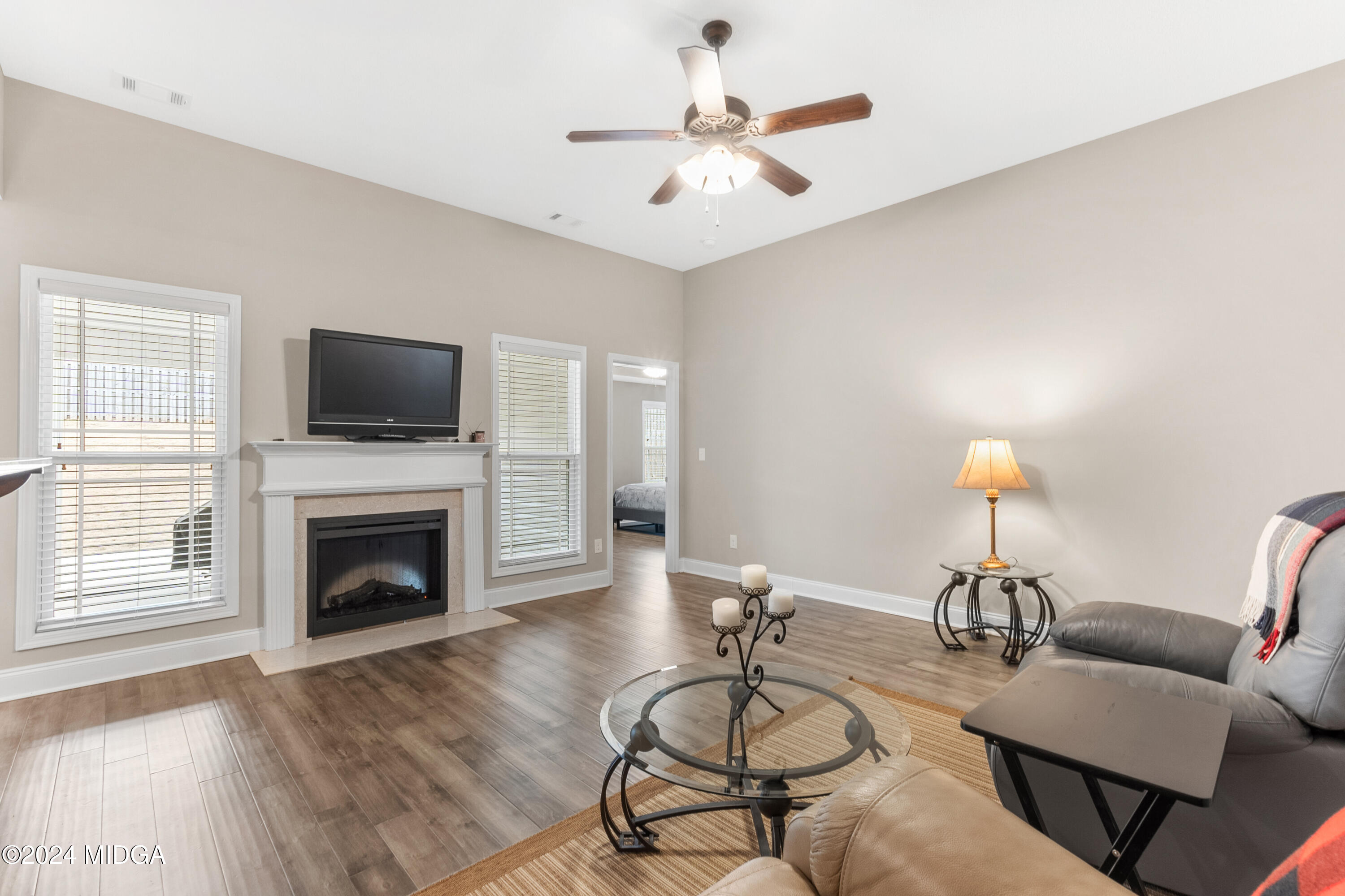 150 Hawks Rdg Trace Byron, GA 31008 - Photo 12 of 51 a living room with furniture a fireplace and a flat screen tv