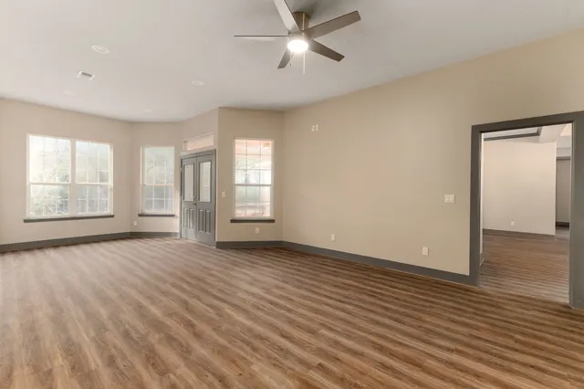 wooden floor in an empty room with a window