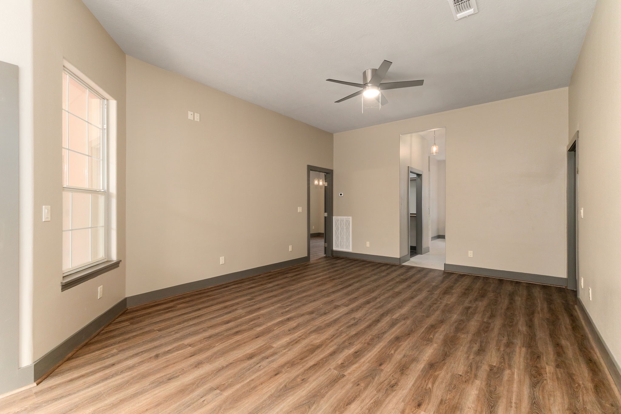 250 Bucek Lane Schulenburg, TX 78956 - Photo 18 of 45 wooden floor in an empty room with a window