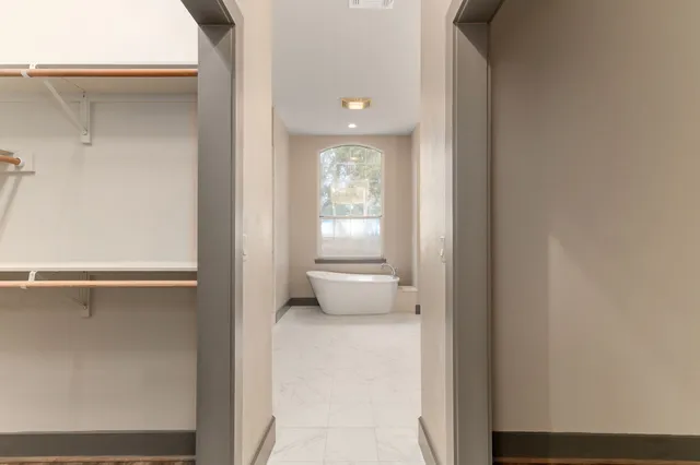 a bathroom with a granite countertop double vanity sink and mirror