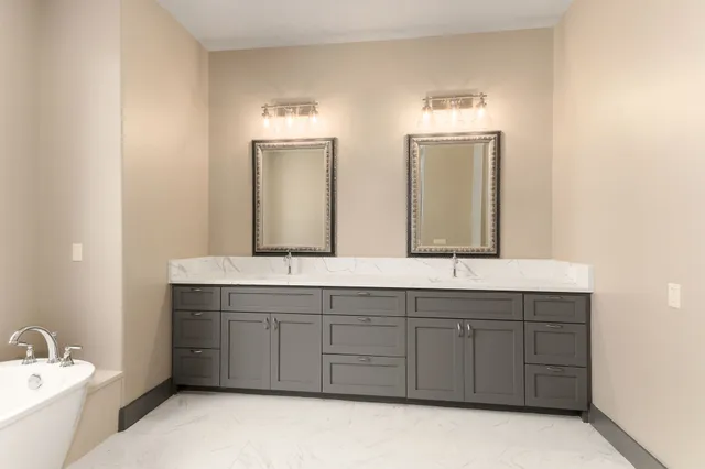 a bathroom with a white tub and shower