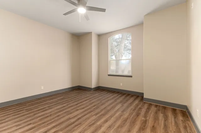 an empty room with closet and a hallway