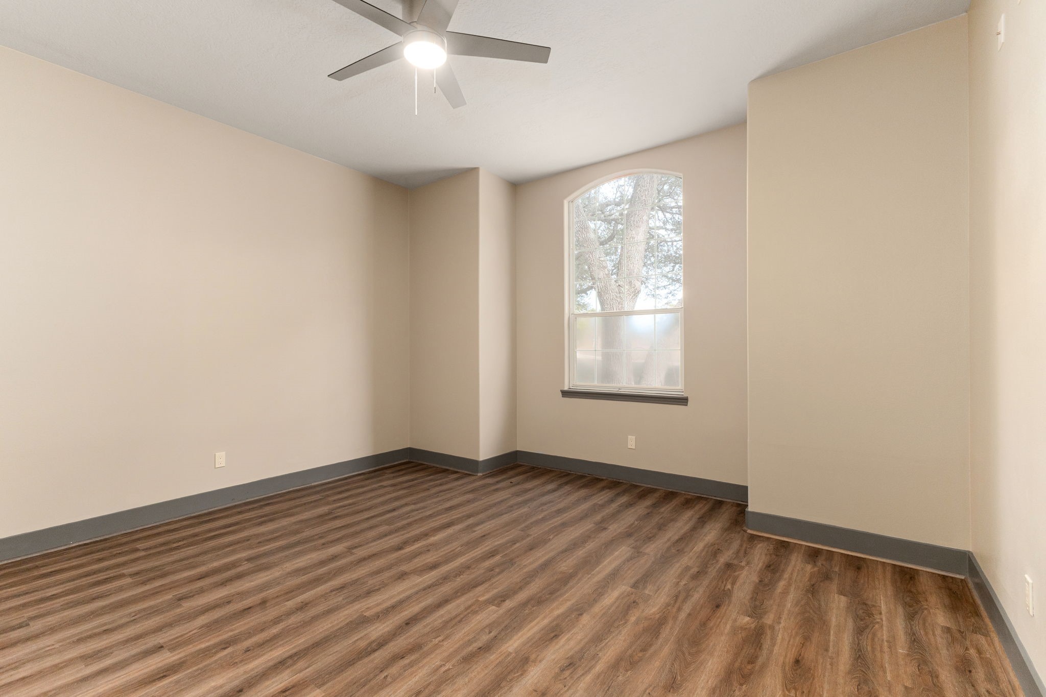 250 Bucek Lane Schulenburg, TX 78956 - Photo 22 of 45 a view of an empty room with wooden floor and a window