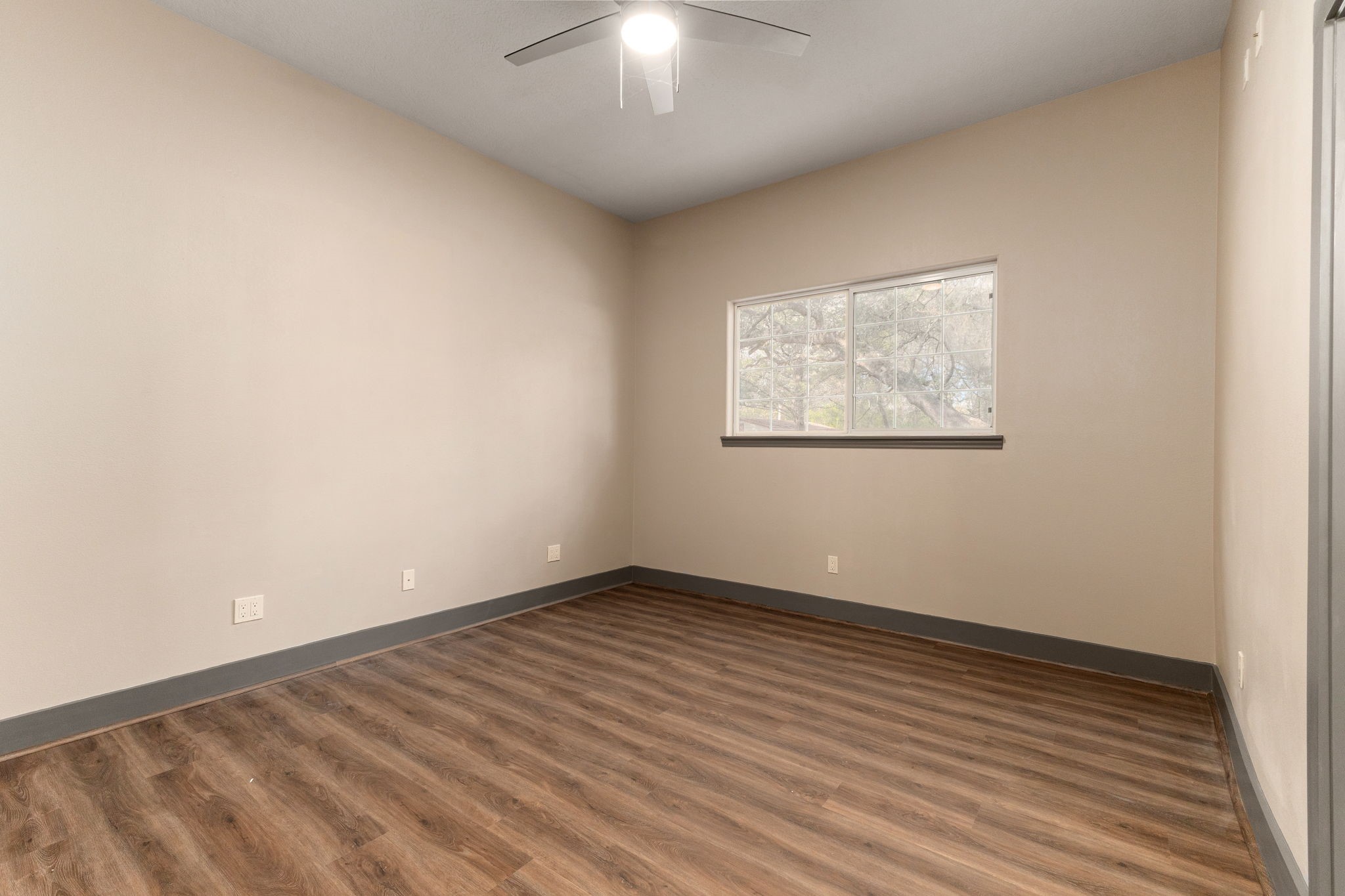 250 Bucek Lane Schulenburg, TX 78956 - Photo 26 of 45 an empty room with wooden floor and windows