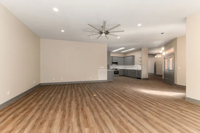 a large kitchen with stainless steel appliances sink a microwave and cabinets