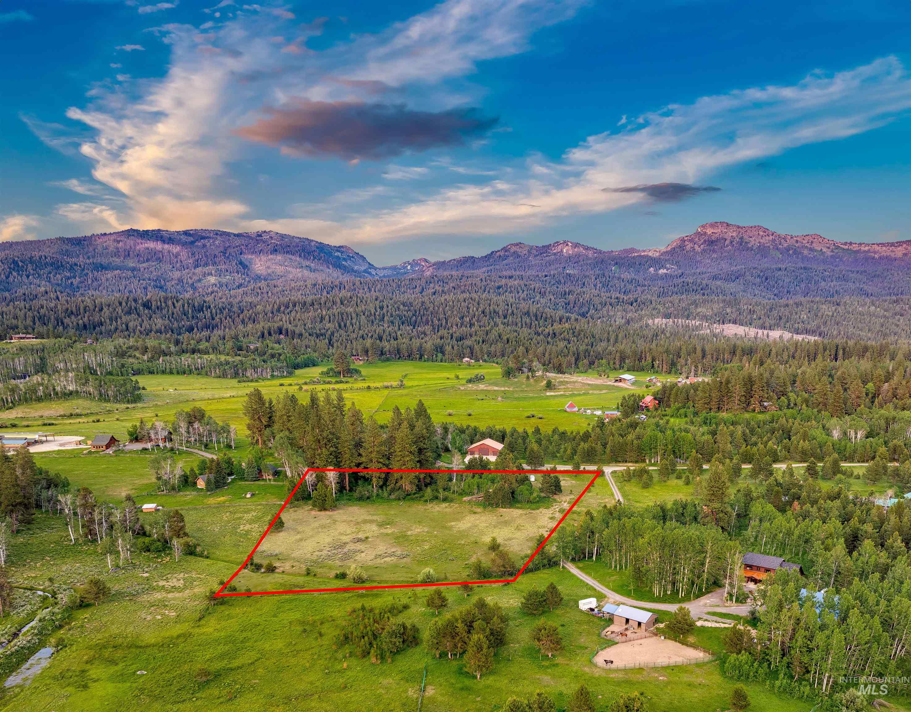 14055 Deerfield Road McCall, ID 83638 - Photo 1 of 19 Aerial view of property's location featuring a mountainous background and property boundaries highlighted