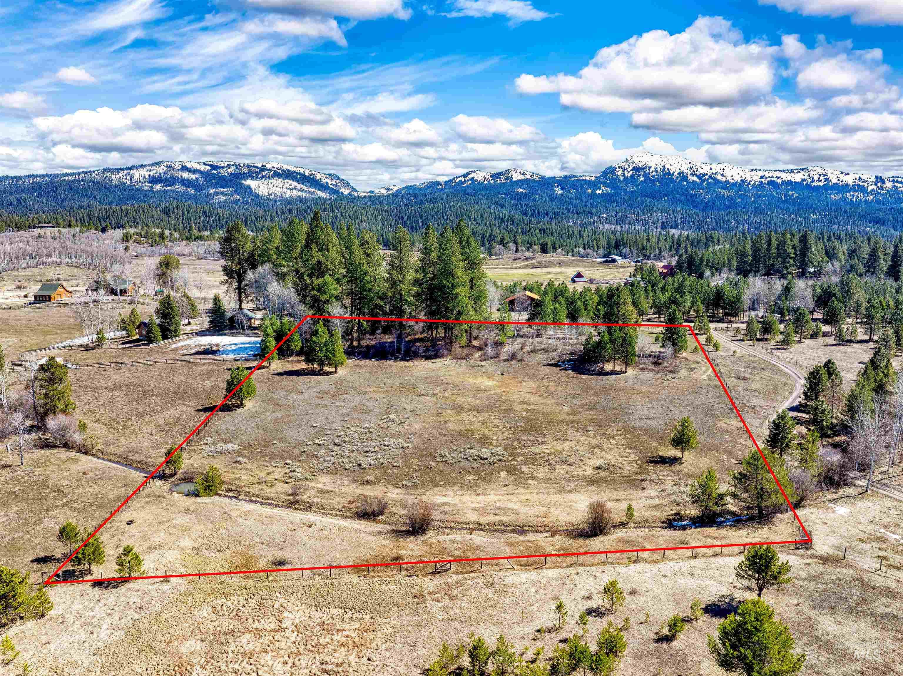 14055 Deerfield Road McCall, ID 83638 - Photo 5 of 19 Aerial view of sparsely populated area featuring property boundaries highlighted and mountains