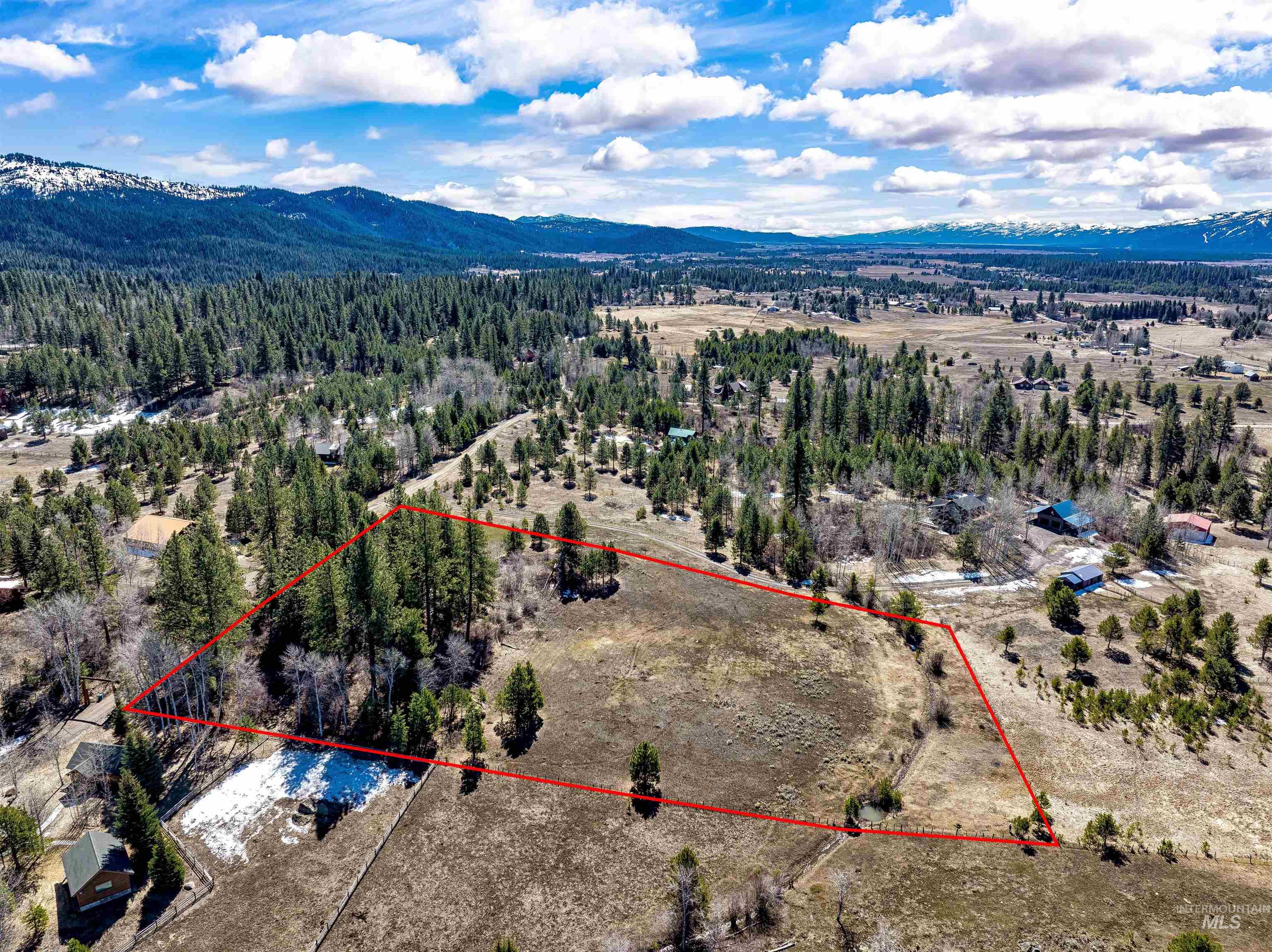 14055 Deerfield Road McCall, ID 83638 - Photo 8 of 19 Aerial view of property and surrounding area with a mountainous background and property parcel outlined