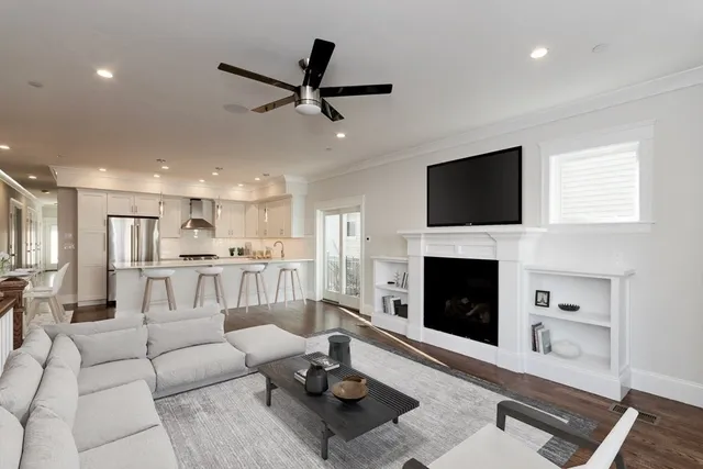 a living room with furniture a fireplace and a flat screen tv