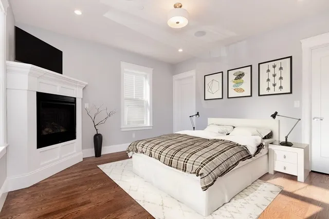 a spacious bedroom with a bed and a fireplace