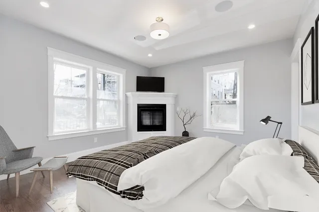 a bedroom with a large bed and a tv