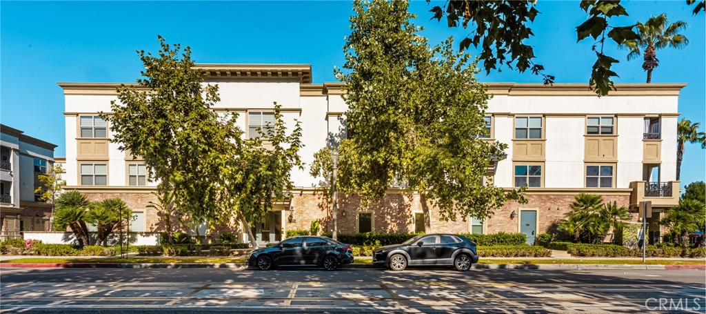 a front view of a building with trees
