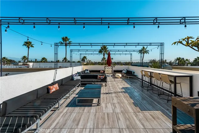 a view of a hallway with wooden floor and a cabinet