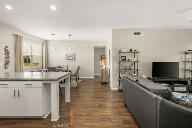 a living room with furniture and a floor to ceiling window