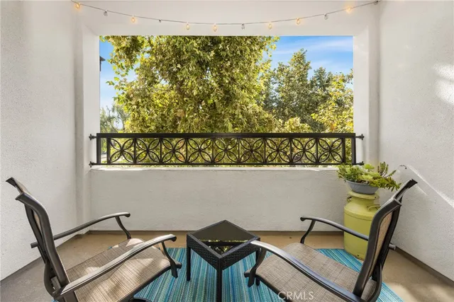 a kitchen with stainless steel appliances granite countertop a refrigerator stove microwave and a dining table with wooden floor