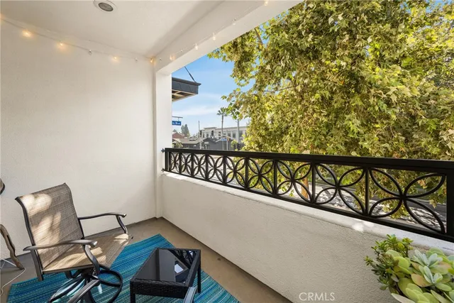 a kitchen with stainless steel appliances a dining table chairs refrigerator and sink