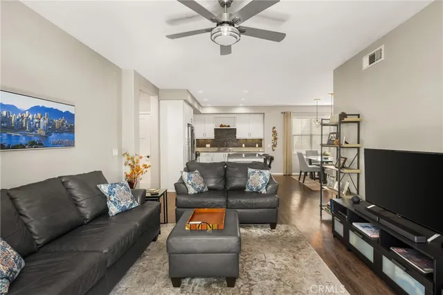 a kitchen with stainless steel appliances granite countertop a refrigerator a stove and a sink