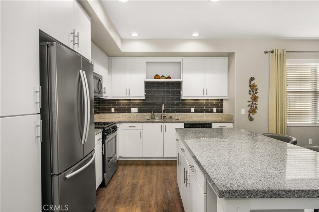 425 South Anaheim Boulevard, Unit 3 Anaheim, CA 92805 - Photo 31 of 53 a kitchen with stainless steel appliances granite countertop a refrigerator a stove and a sink