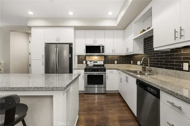 a large bed sitting in a bedroom next to a cabinet