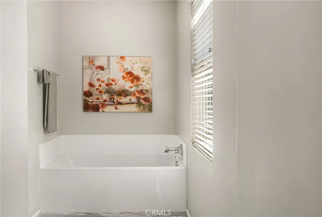 a white bath tub sitting next to a shower