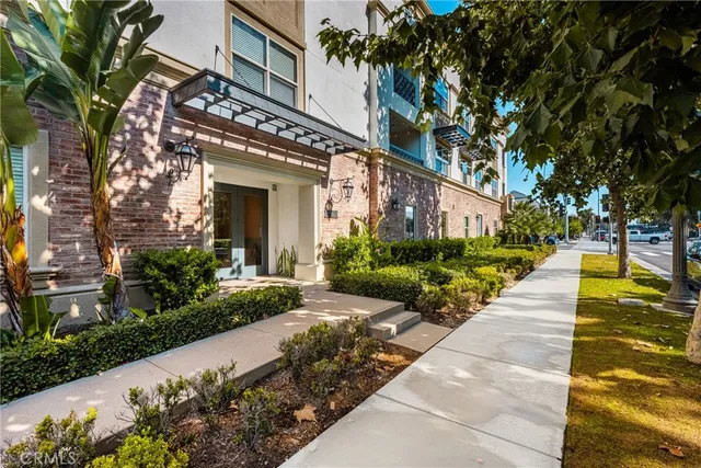 a view of a building with garden and sitting area