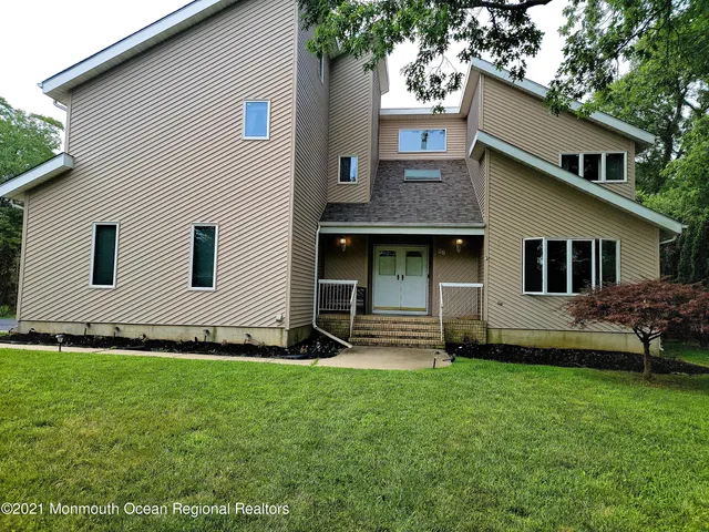 a view of a house with a yard and sitting area