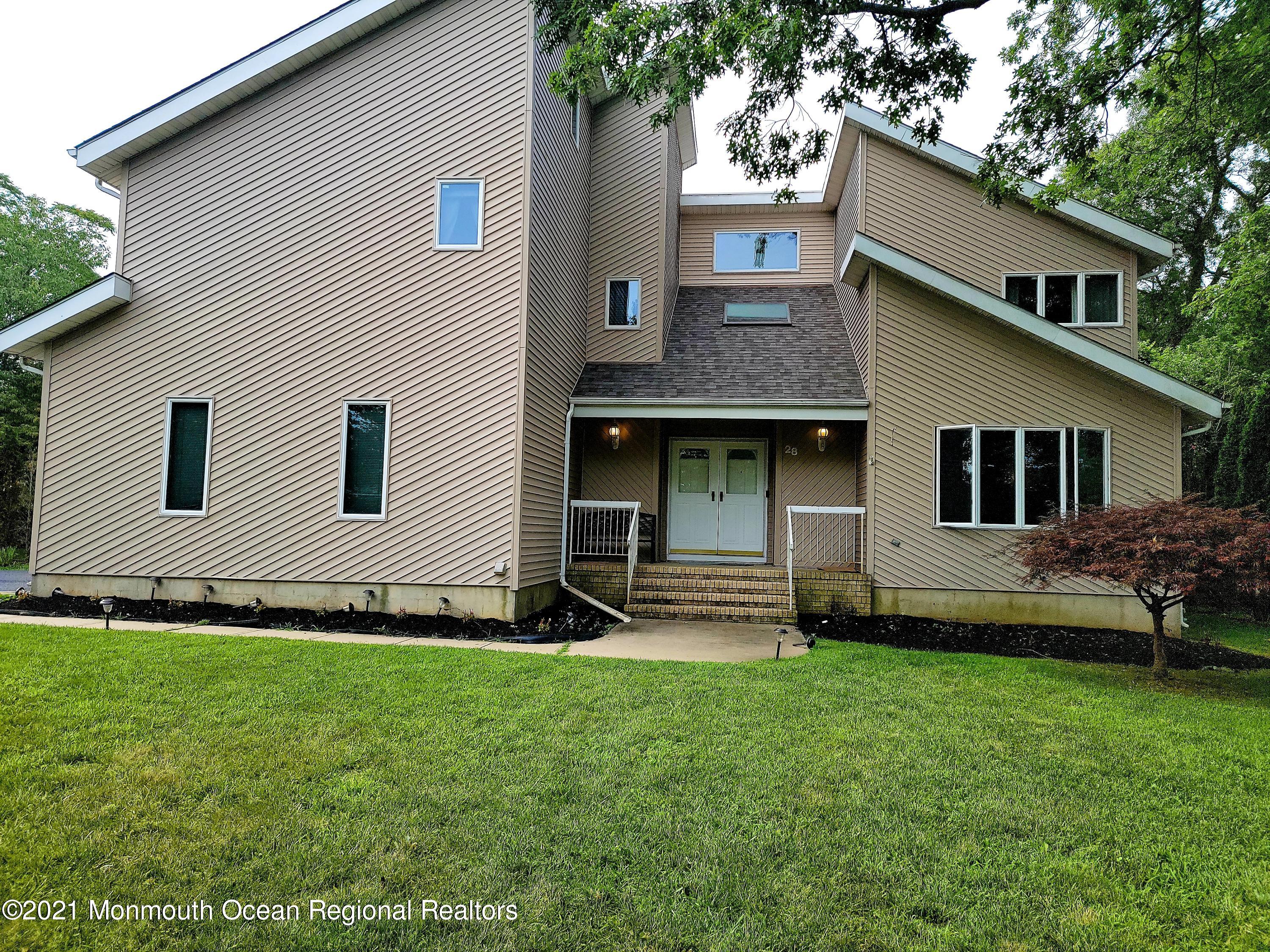 a view of a house with a yard and sitting area