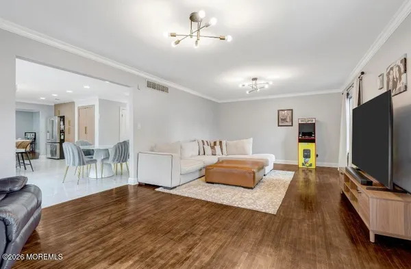 a bedroom with furniture and a flat screen tv