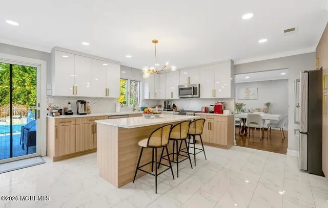 a kitchen that has a lot of cabinets in it and appliances
