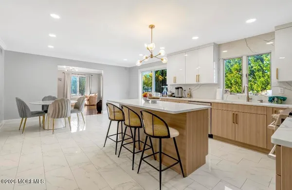 a kitchen with a table chairs sink and cabinets
