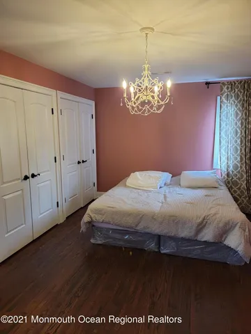 a bedroom with a bed and chandelier
