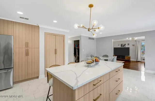 a kitchen with a stove a refrigerator and a sink