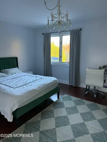 a large bed sitting in a bedroom next to a window