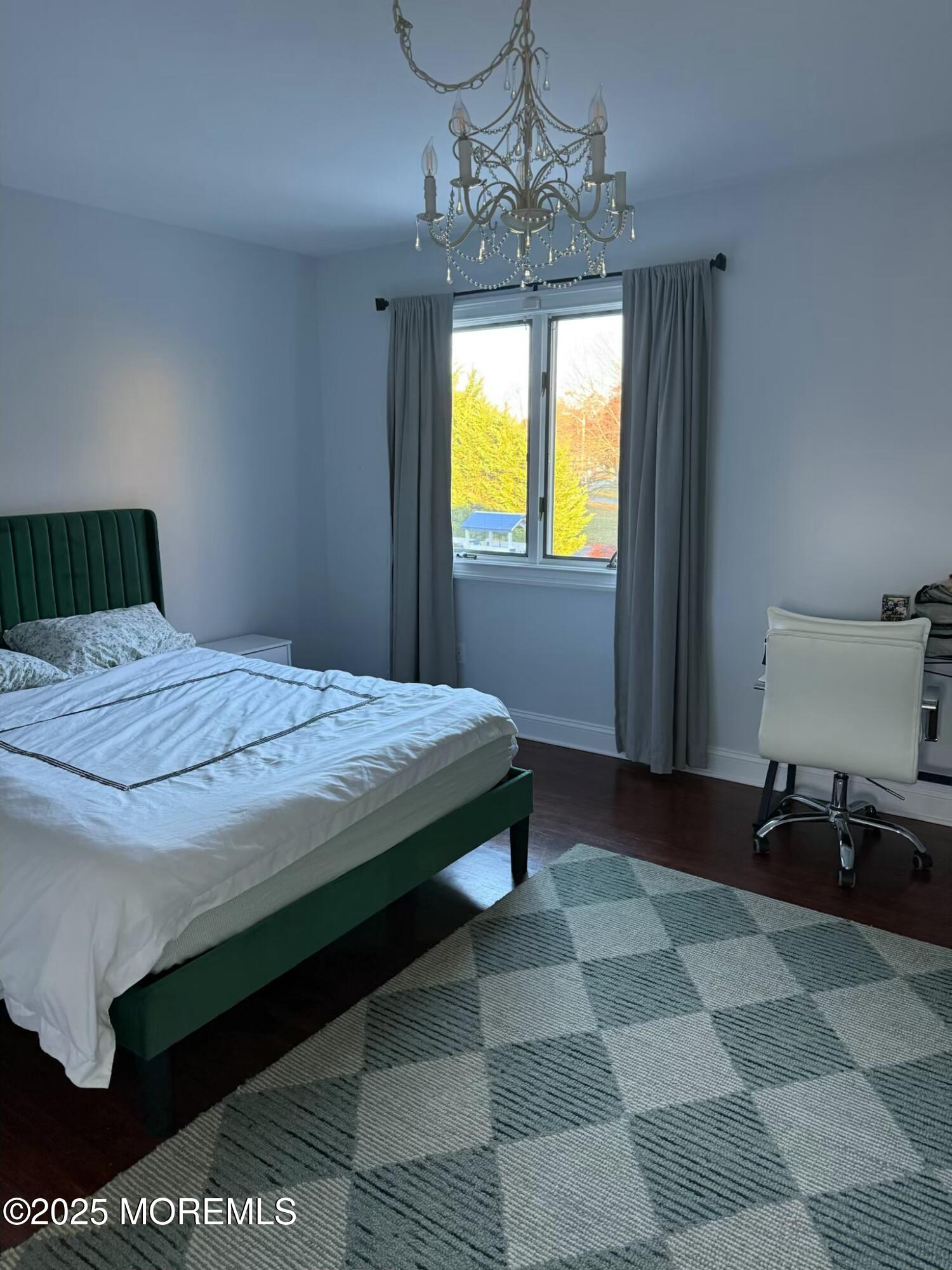 28 Musket Lane Eatontown, NJ 07724 - Photo 23 of 26 a bedroom with a bed and a chandelier