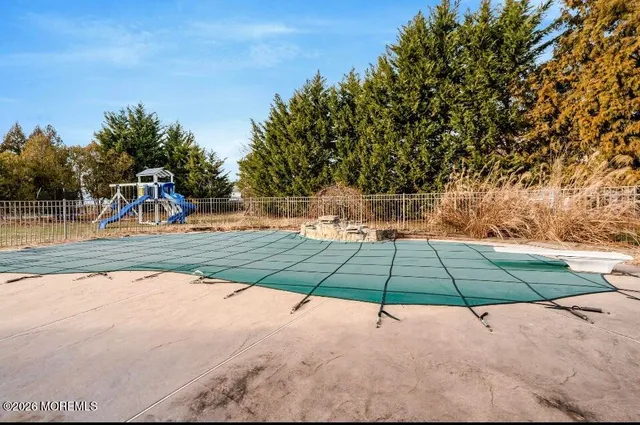a lawn chair sitting under a blue umbrella