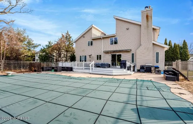 a view of a house with backyard porch and sitting area