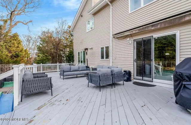 a balcony with furniture and wooden floor