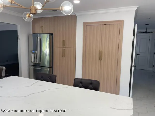 a kitchen with kitchen island granite countertop a sink dining table and chairs