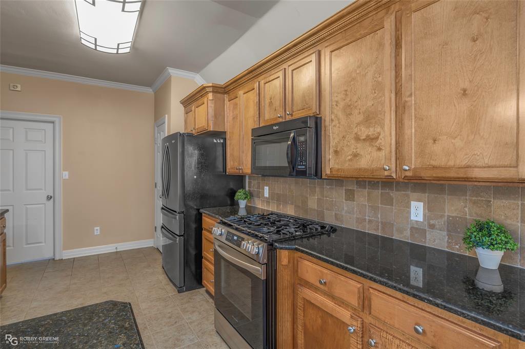 102 Red Fox Circle Haughton, LA 71037 - Photo 8 of 22 a kitchen with stainless steel appliances granite countertop a refrigerator a stove and a sink with wooden floor