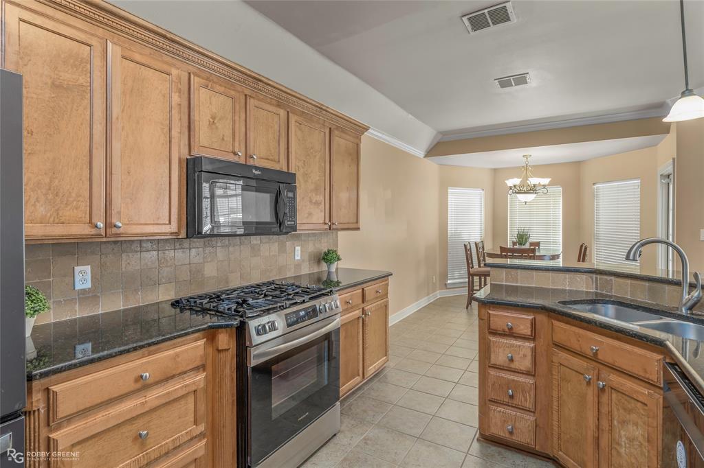102 Red Fox Circle Haughton, LA 71037 - Photo 9 of 22 a kitchen with granite countertop a stove sink and cabinets