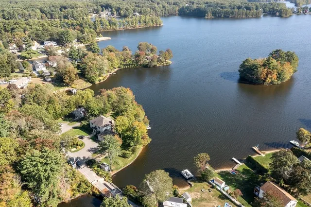 a view of a lake with lawn chairs
