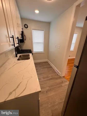 a room with wooden floor and furniture