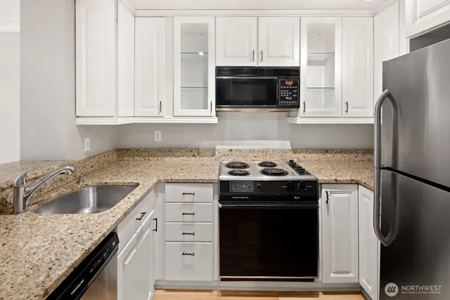 a kitchen with a refrigerator sink and stove
