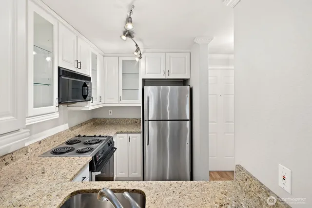 an empty room with windows and fireplace