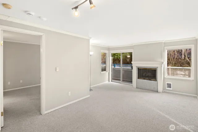 a view of empty room with a fireplace