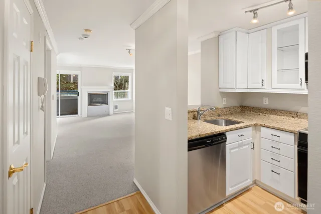 a kitchen with granite countertop white cabinets and white appliances