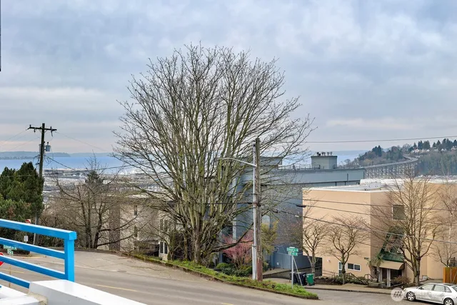 a view of a kitchen with a sink and refrigerator