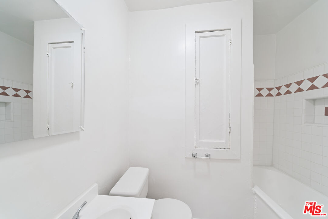 1267 Vin Scully Avenue, Unit 24 Los Angeles, CA 90026 - Photo 7 of 9 a bathroom with a bathtub and a shower